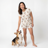 Woman wearing a pajama set with a dog on a white background[PastelMeadows]