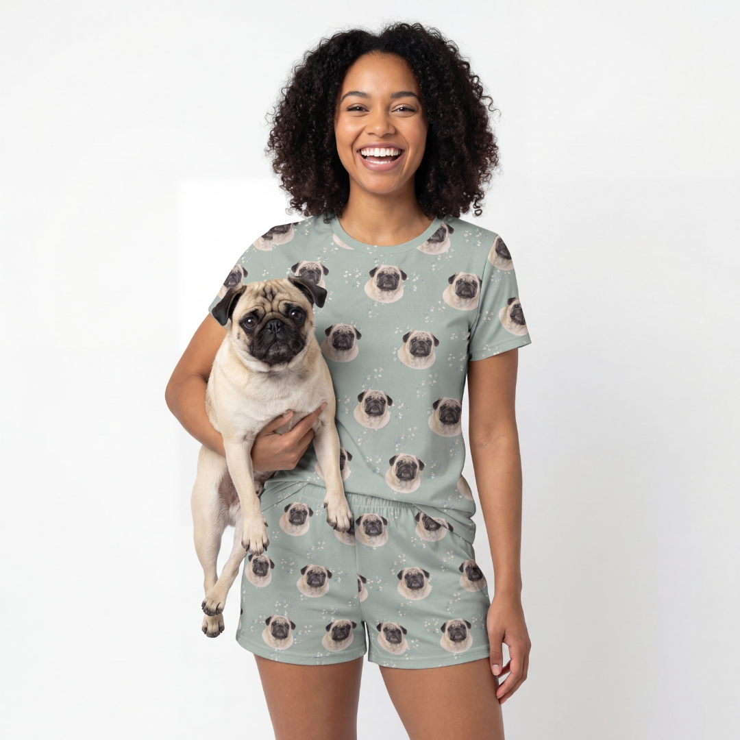 Woman wearing a pug-themed pajama set holding a pug dog on a white background[VintageBloom]