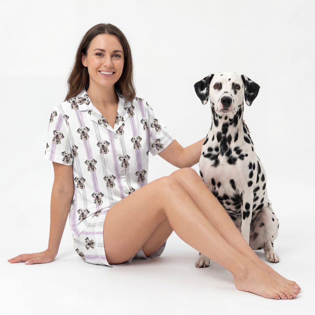 Woman wearing a short button down pajama set with a Dalmatian dog on a white background