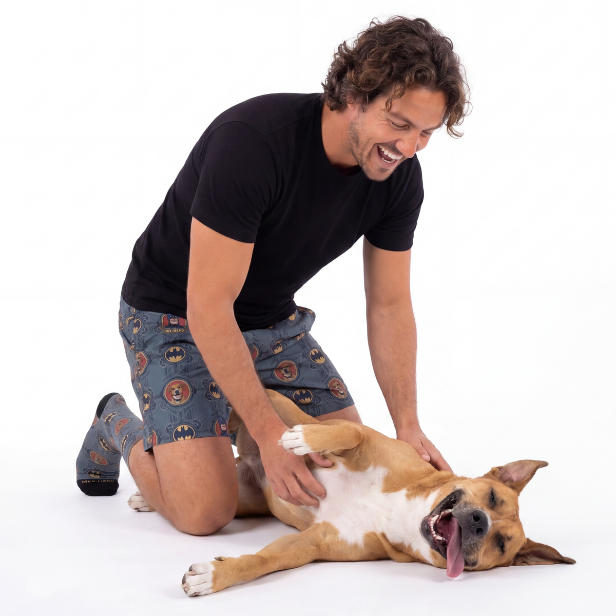 Man playing with a dog on a white background
