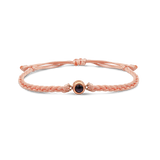 Pink braided bracelets with a black bead charm.