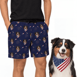 Person wearing navy shorts with dog pattern, next to a dog wearing an American flag bandana[Fireworks]