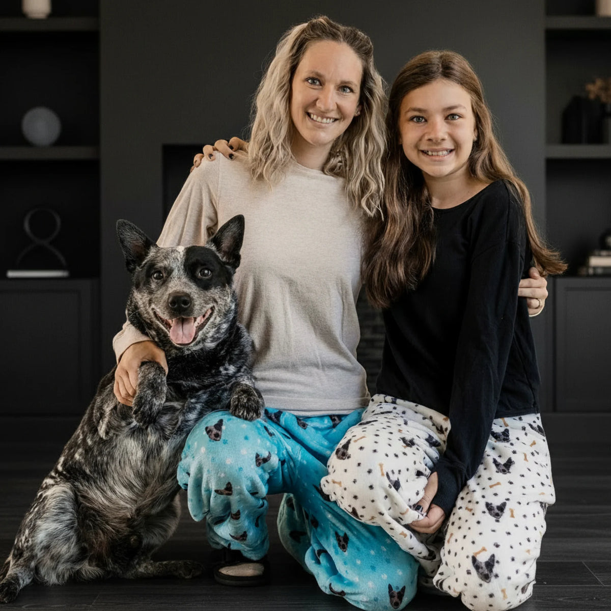 Woman and young girl with a dog in pajamas indoors