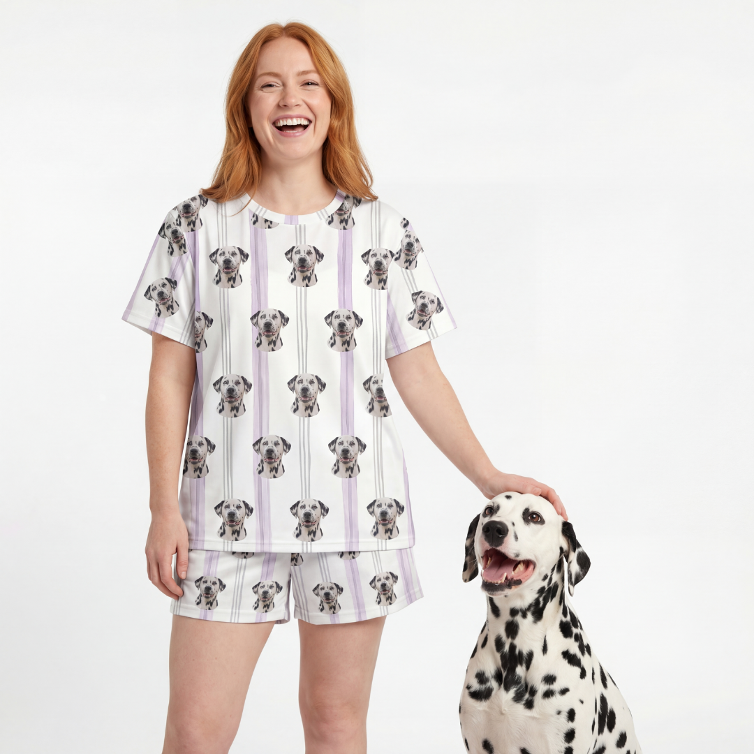 Woman wearing a Dalmatian patterned pajamas standing next to a Dalmatian dog on a white background[LilacStripes]