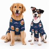 Two dogs sitting side by side wearing matching navy blue Christmas-themed dog shirts with printed dog faces, Santa hats, and holiday text, photographed on a clean white background.
