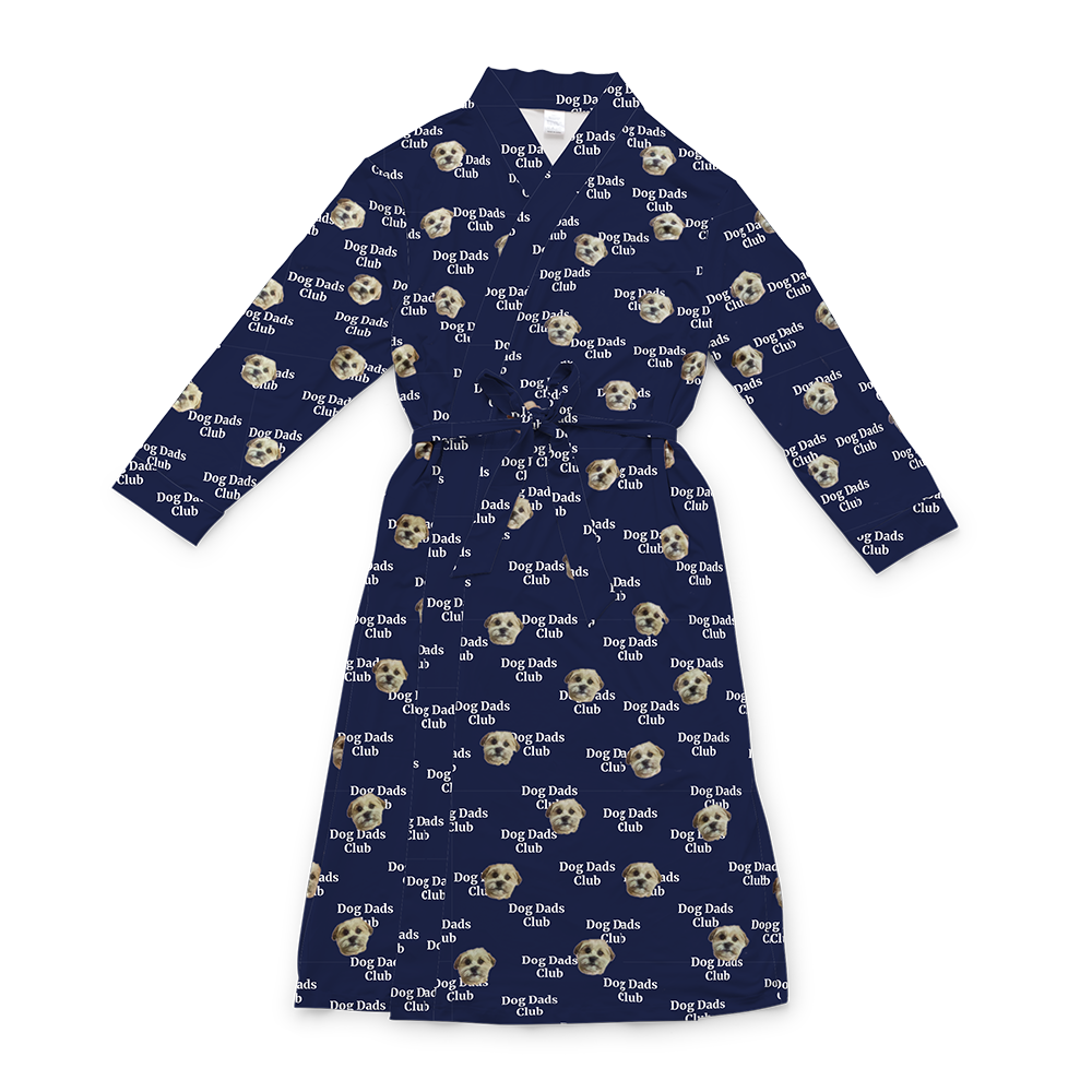 A navy blue full-length robe with a tie belt, featuring a repeating custom pattern. The pattern includes several close-up photos of a small, light-colored dog's face, interspersed with the white text "Dog Dads Club" in a repeating diagonal pattern.