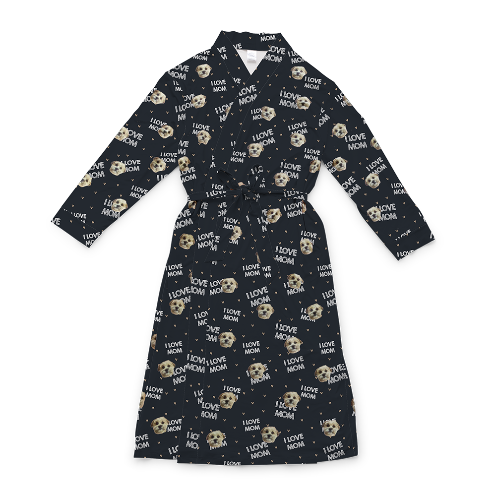 A black full-length robe with a tie belt, featuring a repeating custom pattern. The pattern includes several close-up photos of a small, light-colored dog's face, interspersed with the white text "I LOVE MOM" and small heart shapes.