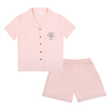 Premium women’s bamboo pajama set in light pink which contains a short sleeve shirt with buttons and a short pajama. Custom pet portrait on the chest pocket