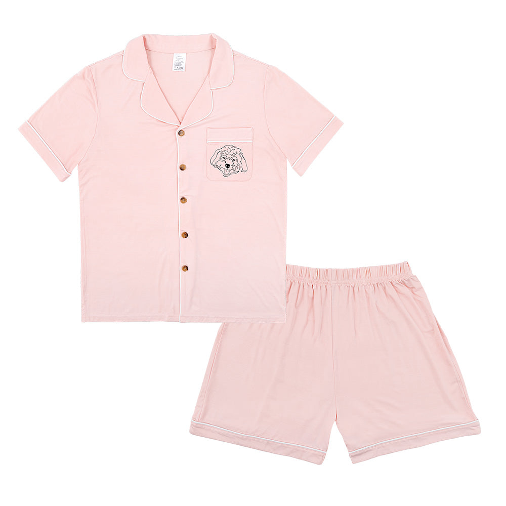 Premium women’s bamboo pajama set in light pink which contains a short sleeve shirt with buttons and a short pajama. Custom pet portrait on the chest pocket