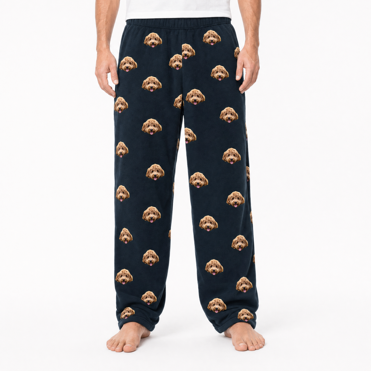black pajama pants with dog pattern worn by a person on a white background