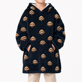 Black blanket hoodie with dog face pattern worn by a person on a white background