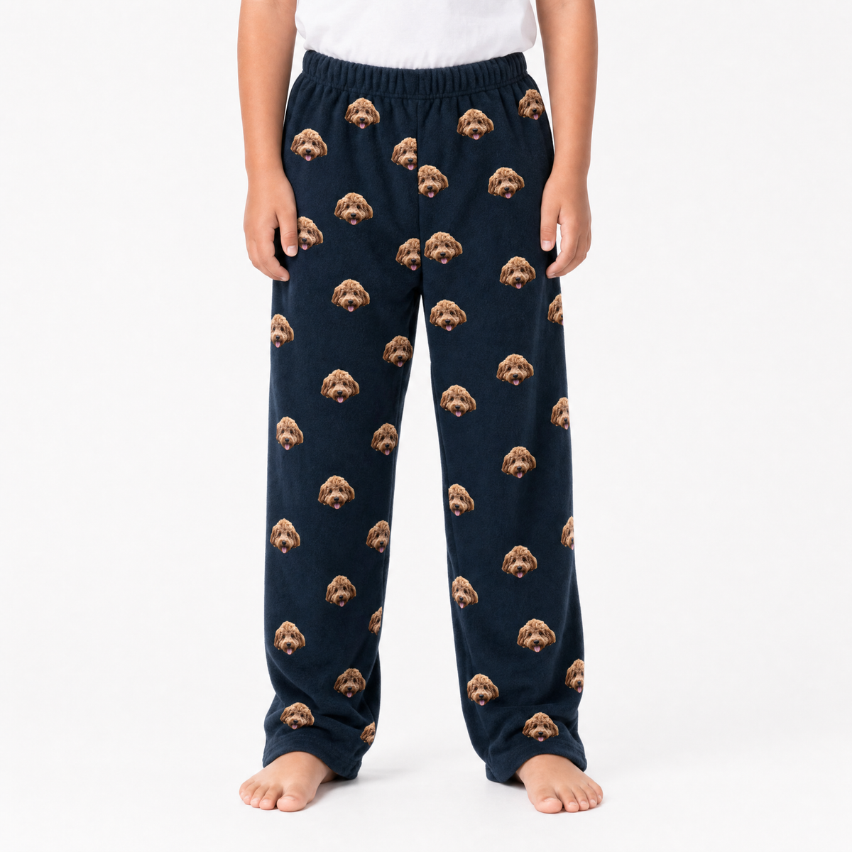 Black pajama pants with dog pattern worn by a person on a white background