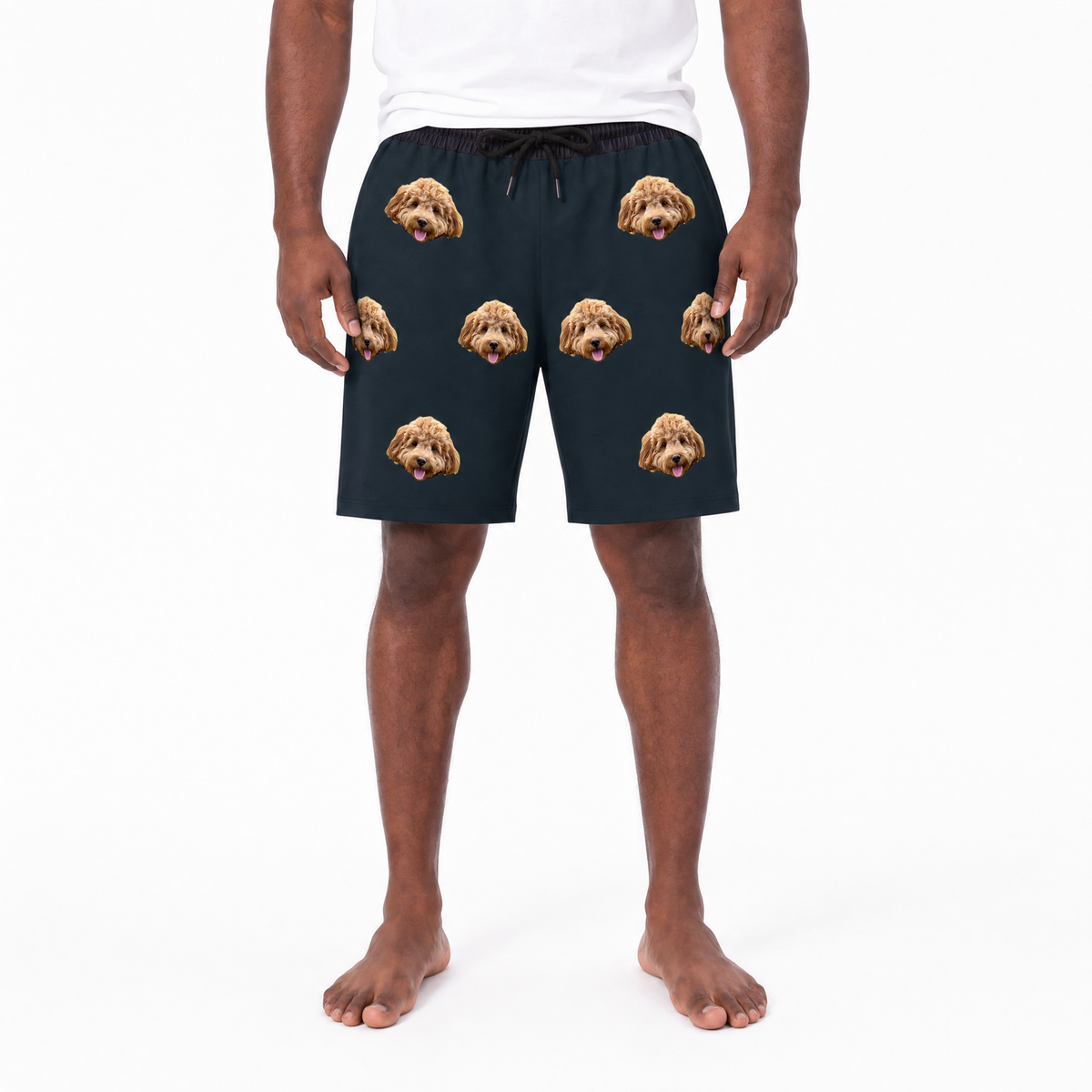 Person wearing black shorts with dog face pattern on a white background