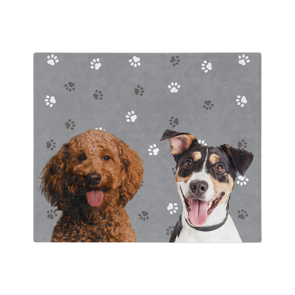 Gray blanket with paws featuring the portraits of two dogs.