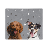 Gray blanket with paws featuring the portraits of two dogs.