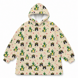 A cream-colored fleece hoodie featuring an all-over Christmas-themed print with green elfs, black-and-white cats in hats, candy canes, and paw prints.