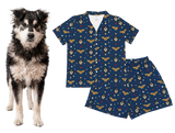 Husky dog next to a matching blue pajama set with dog pattern