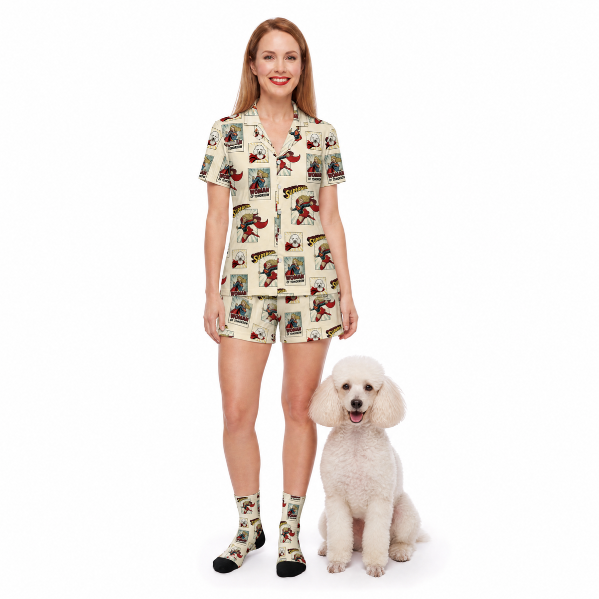 A woman modeling a matching short-sleeve button-front shirt and shorts set with socks, standing next to a small white poodle on a plain white studio background. The shirt and shorts have a comic book vintage-style illustrated print on a light cream base, and the socks match the print.