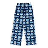 A pair of navy blue pajama pants featuring a repeating 'Scotty Smokey' winter-themed pattern with snow globes, snowmen, and snowflakes, shown flat against a white background.