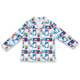 A long-sleeve collared button-front top with an all-over cartoon dog collage print in blue, white, red, and tan, shown on a plain white background.