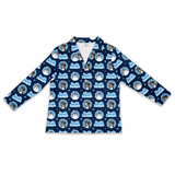 A long-sleeve collared shirt with a navy blue background and a repeating pattern of circular dog portraits, snowflakes, and the text 'Just Jolly Christmas' in light blue and white.