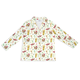 A long-sleeve button-up shirt with a festive Christmas-themed all-over print on a white background. The pattern features illustrations of gingerbread men in Santa hats, Christmas trees, ornaments, and holiday decorations.