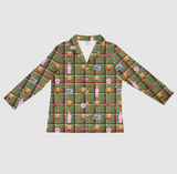 A long-sleeve button-up shirt with a green plaid pattern and a repeating print of golden retriever dog faces, pink hearts, and small pink dog accessories, shown flat against a light gray background.