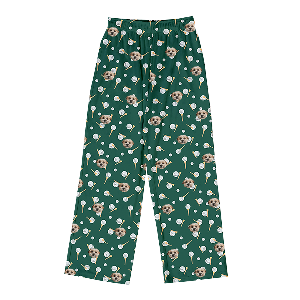 Green pajama pants with an all-over pattern of small dog faces, golf balls, and golf tees.