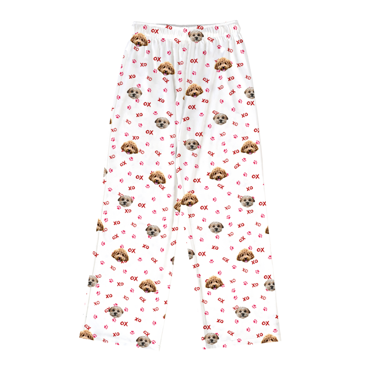 A pair of white, long pajama pants with an elastic waistband, laid flat on a solid light gray background. The pants have a repeating pattern featuring two different dog faces. The pattern also includes small pink "XO" text and scattered pink paw prints.