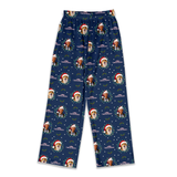 A pair of navy blue Christmas-themed lounge pants featuring a repeating pattern of dog portraits wearing Santa hats, decorated with snowflakes and the text 'Merry Christmas'.