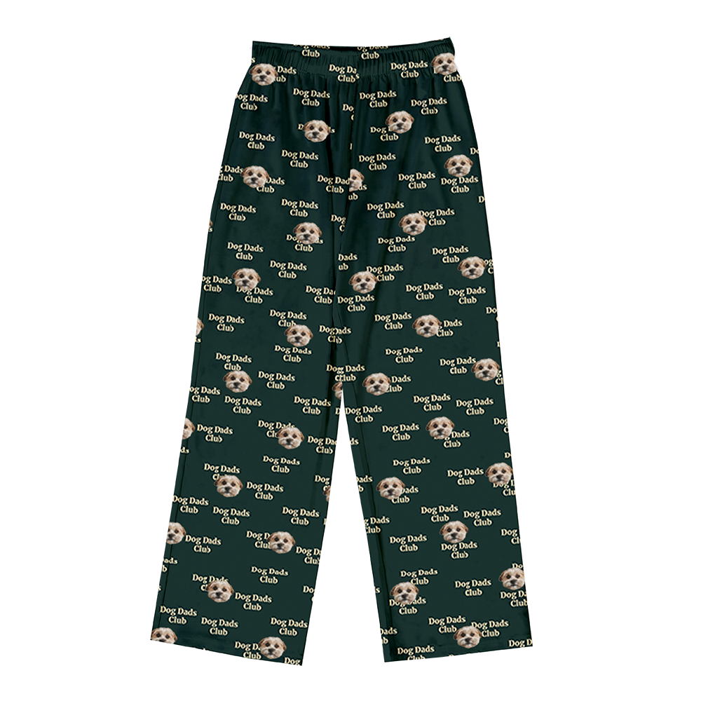 Dark green pajama pants covered in a repeating pattern. The pattern features alternating elements: the phrase "Dog Dads Club" in text, and smiling headshots of a dog.