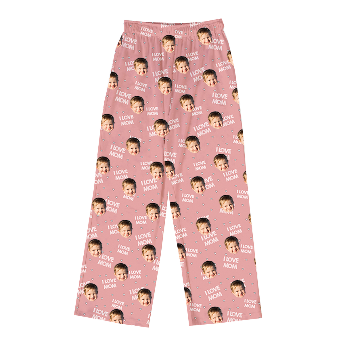 Pink pajama pants with a repeating pattern of a smiling child’s face and the phrase “I LOVE MOM” scattered across the fabric, along with small heart icons.