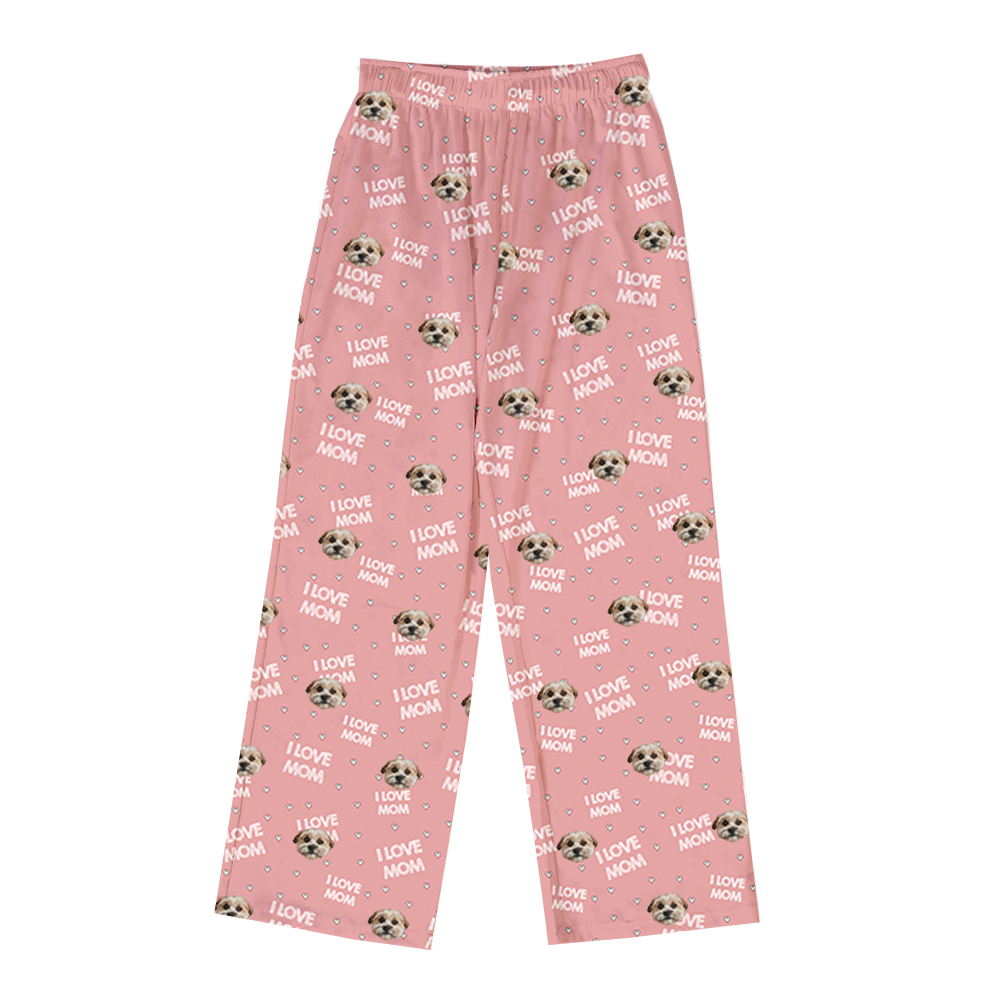 Pink pajama pants featuring a repeating pattern of one dog face, small hearts, paw prints, and the phrase “I LOVE MOM” throughout.