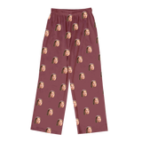 Maroon pajama pants featuring a repeating print of the same smiling woman’s face across fabric[MaroonPajamaPants]