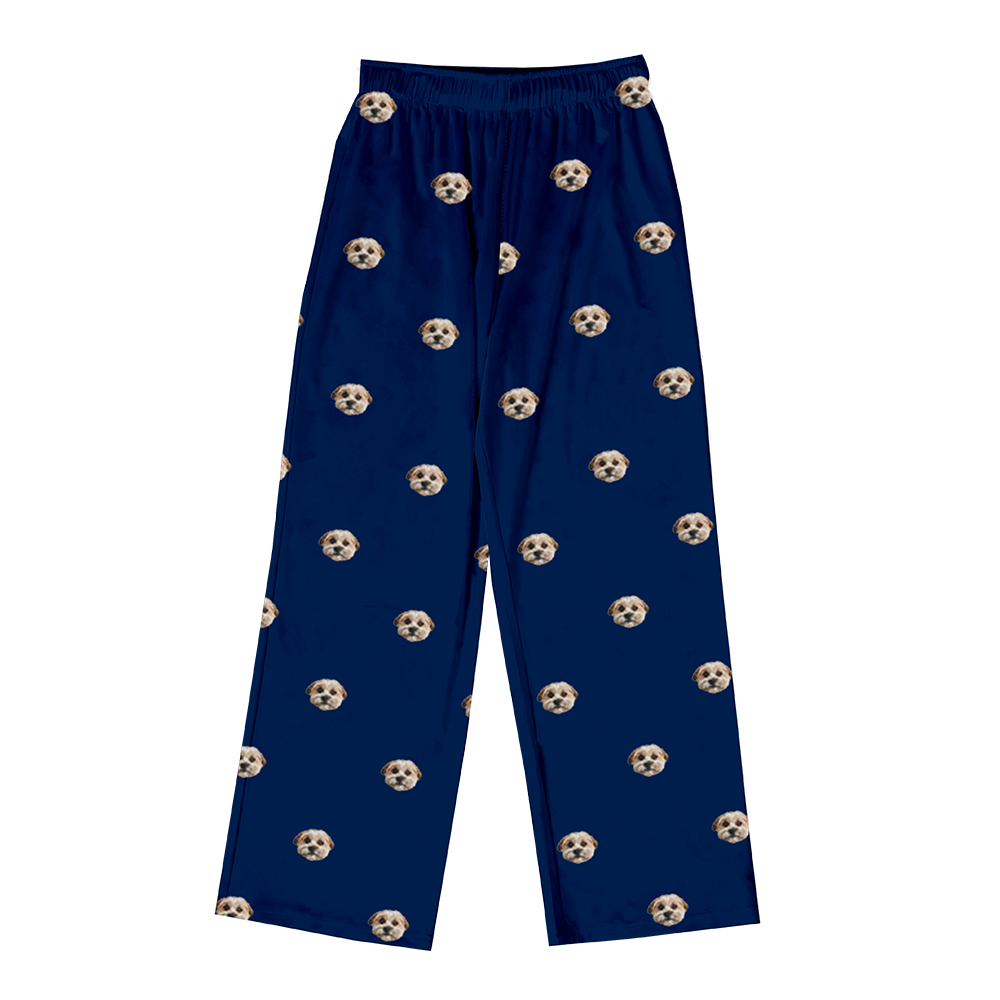 Full-length pajama pants in solid navy blue, featuring an elastic waistband and a scattered, repeating pattern of dog faces.