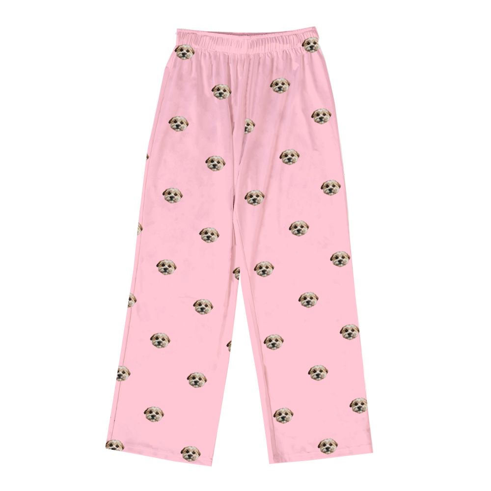 Pink long pajama pants with an all-over custom dog face pattern, shown front-facing against a white background.