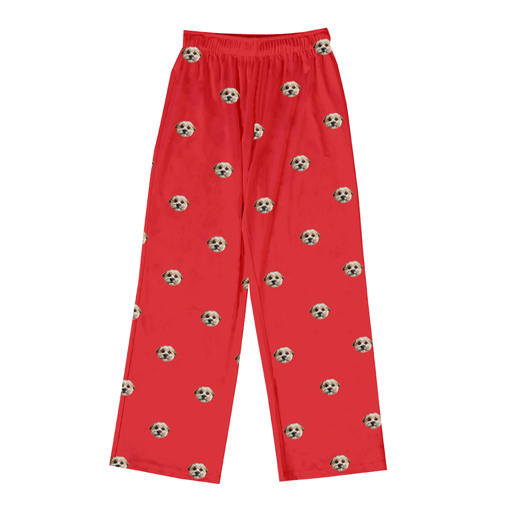 Personalized pajama pants on a bright red background, featuring a repeating pattern of the face of a single small dog.