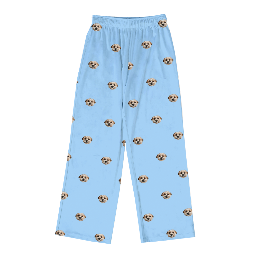 Sky-blue pajama pants featuring an all-over repeating pattern of a small light-colored dog’s face.