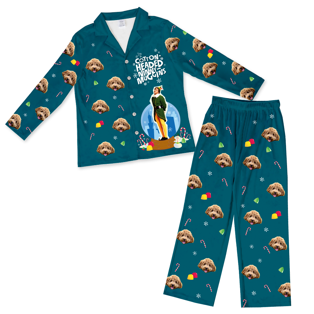 Teal pajama set printed with a repeating dog's face pattern, candy canes, and colorful shapes; the top features the phrase "Cotton Headed Ninny Muggins" with an elf figure.
