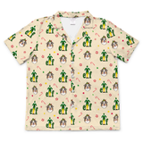 A short-sleeve button-up camp collar shirt in beige, featuring an all-over Christmas elf print with green figures, Santa faces, candy canes, and paw prints.