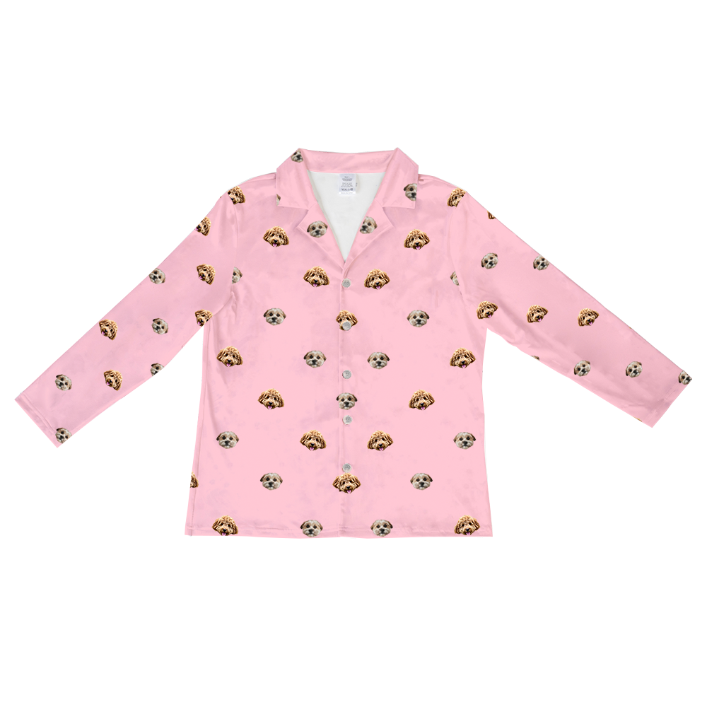 Pink long-sleeved button-up pajama shirt with collar, featuring a scattered pattern of realistic doodle dog faces in tan, cream, and brown colors.