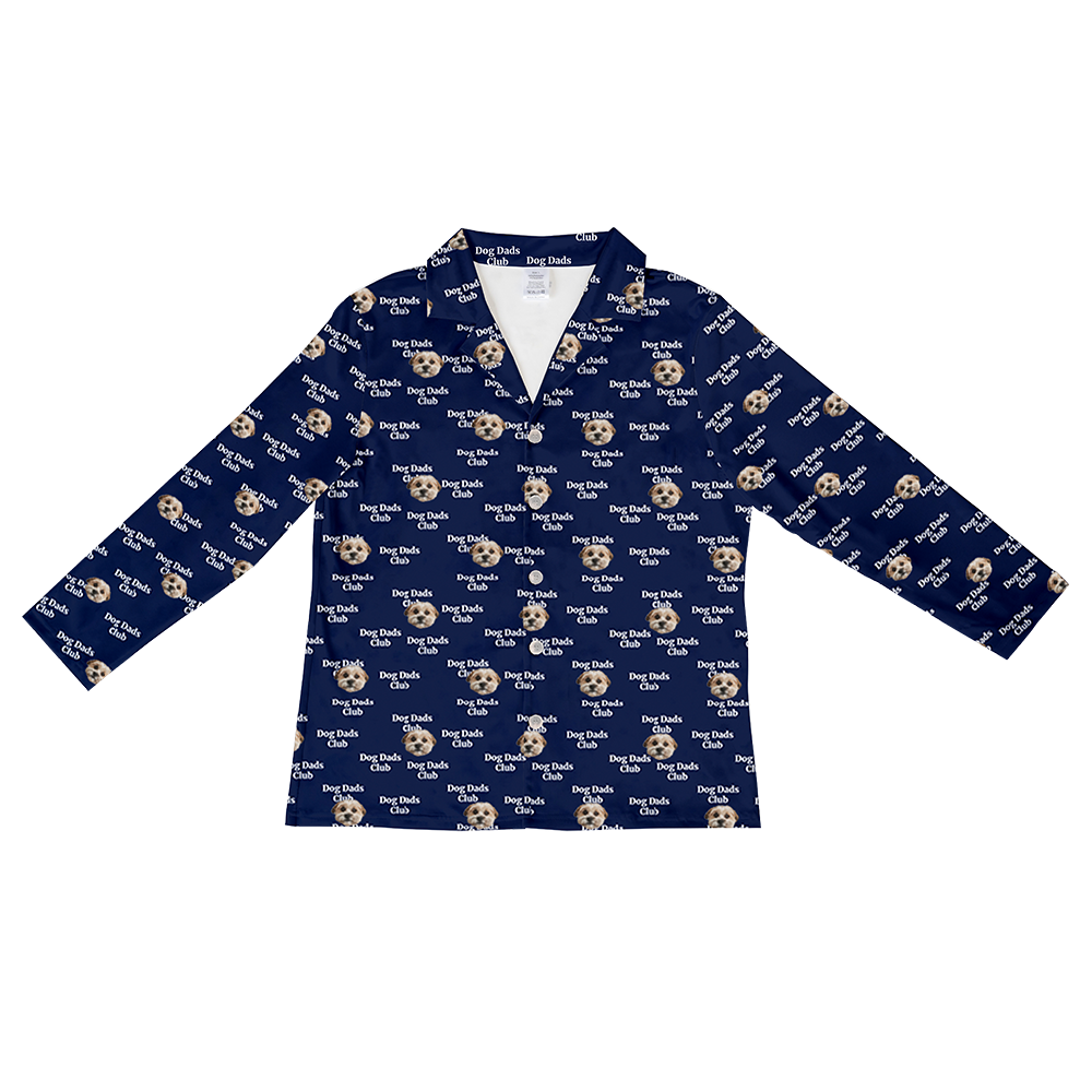 Long-sleeve navy button-down pajama top featuring an all-over pattern of small dog faces and white text that reads "Dog Dads Club".