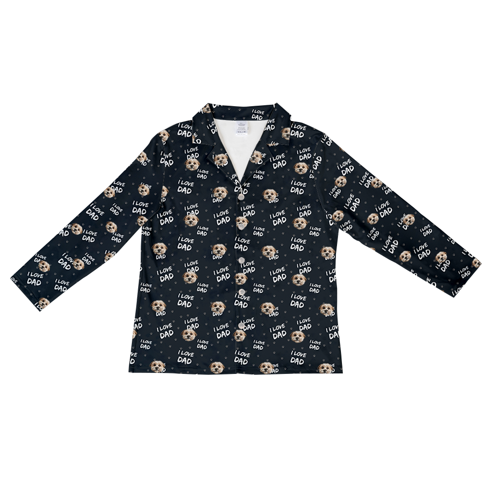 Black long-sleeve button-down pajama top featuring an all-over pattern of a dog’s face, gray paw prints, and the phrase “I LOVE DAD” repeated in white lettering.