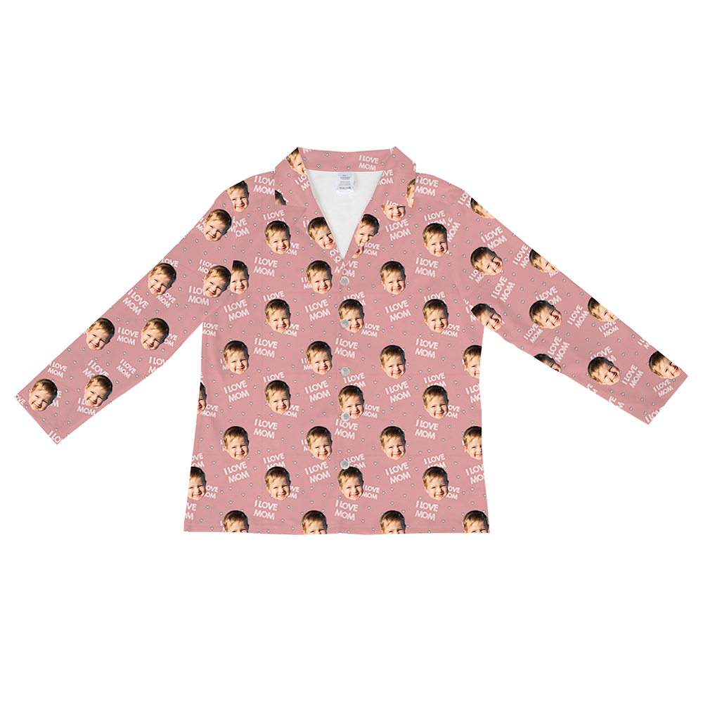 Long-sleeved, button-down pajama shirt in dusty rose pink, patterned with repeating images of a happy baby's face, small white dots, and the text 'I LOVE MOM'.