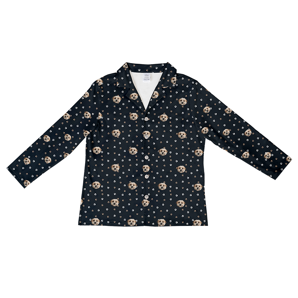 
Black long-sleeve button-down pajama top patterned with white and brown paw prints and the custom photo head of a single, light-colored dog.