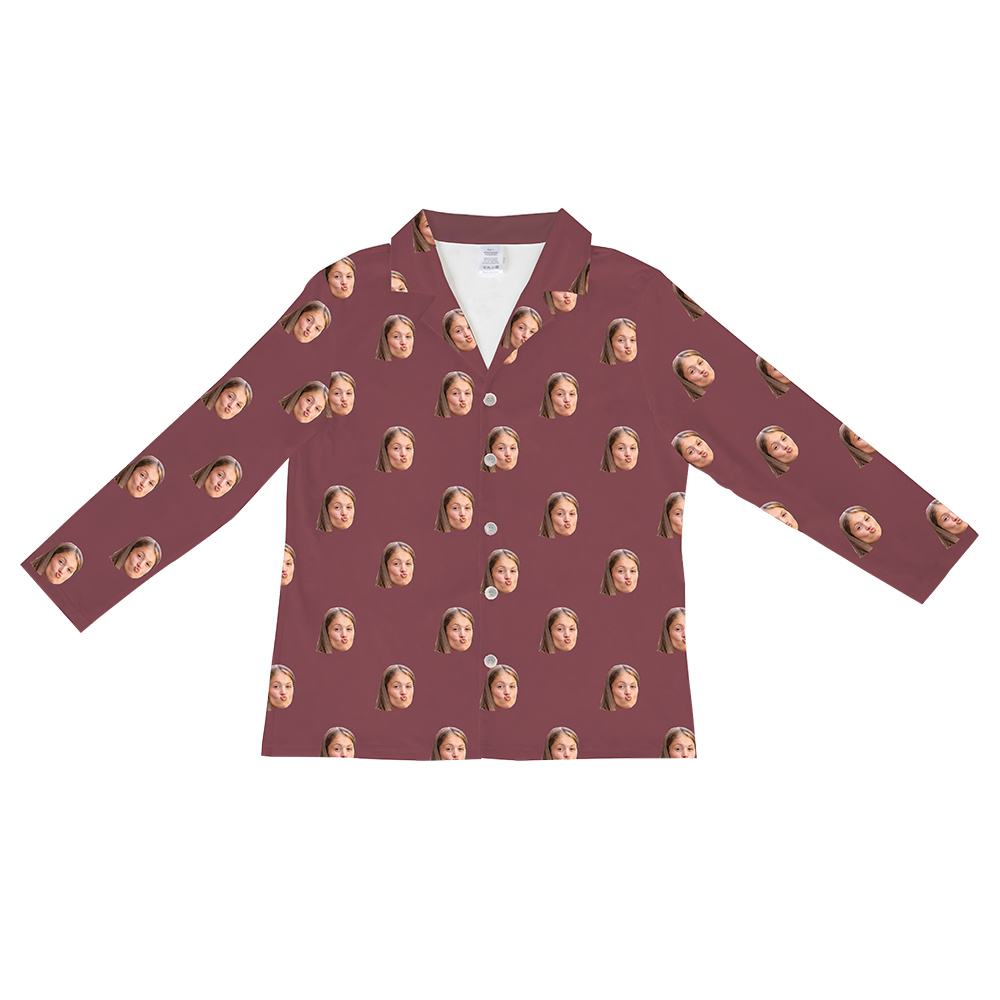 Long-sleeved, button-down pajama shirt in a solid deep maroon or burgundy color, featuring a repeating pattern of a young girl's face.