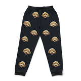 Black pajama pants with dog face pattern on a white background
