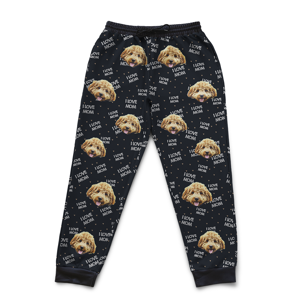 Black jogger-style sweatpants featuring a custom pattern with a dog’s face repeated throughout and white text that says ‘I Love Mom’ with small heart accents.