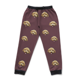 Maroon sweatpants featuring a repeating dog's face pattern.