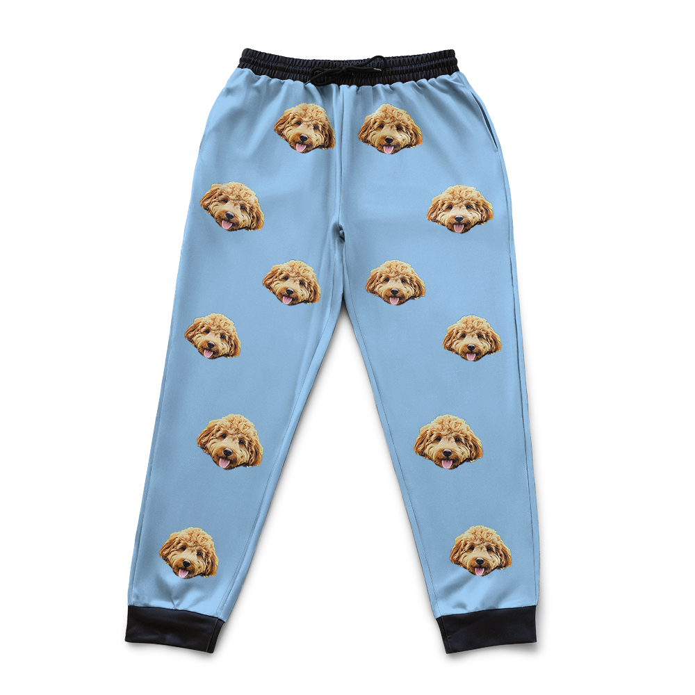 Sky blue pajama pants with dog face pattern on a white background